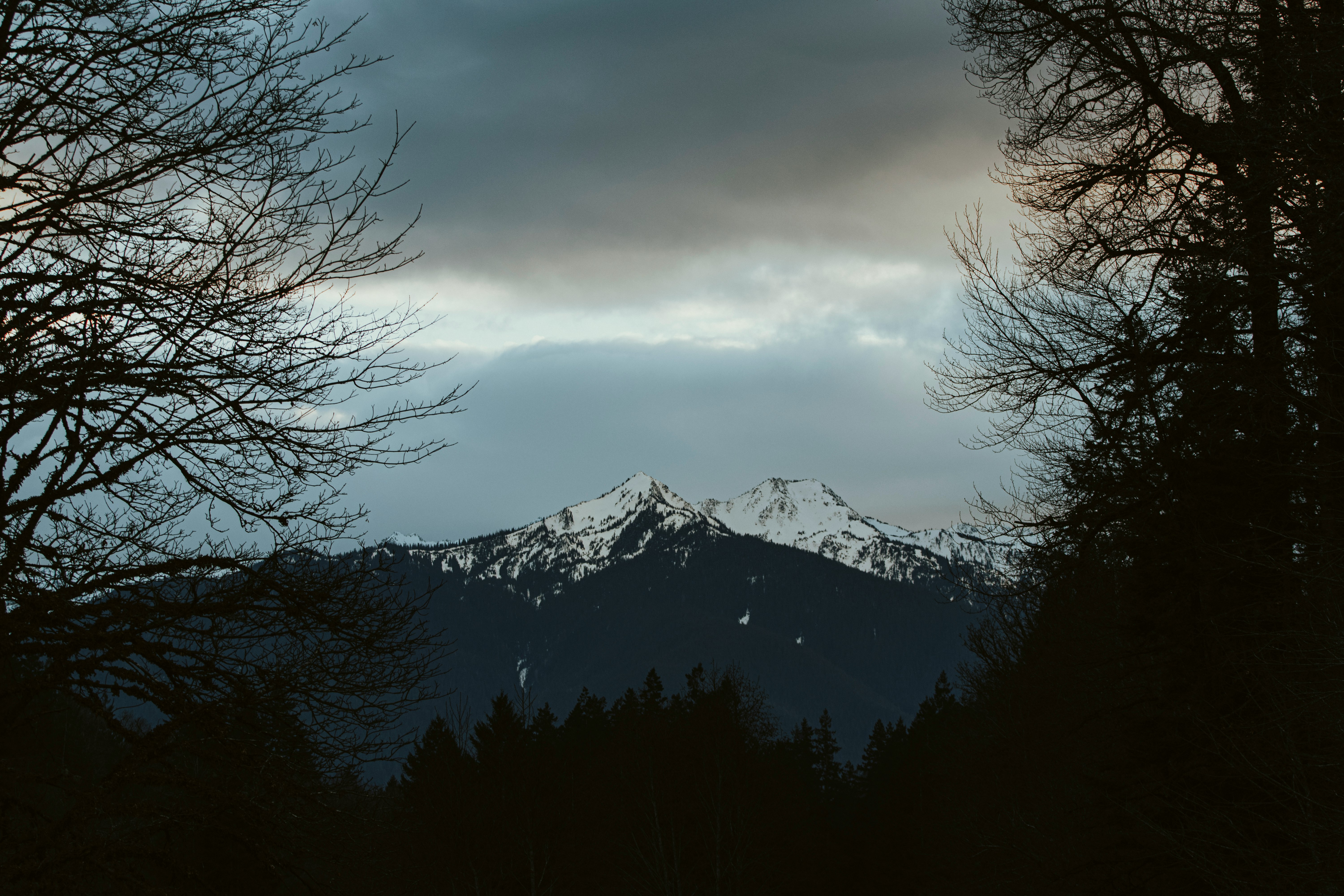 snow covered mountain under cloudy sky during daytime